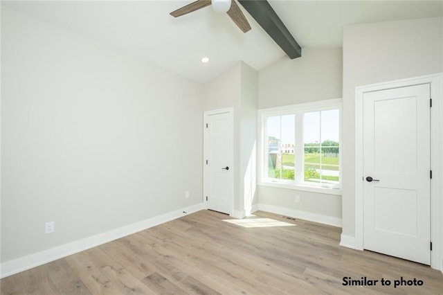 unfurnished bedroom with ceiling fan, light hardwood / wood-style floors, and lofted ceiling with beams