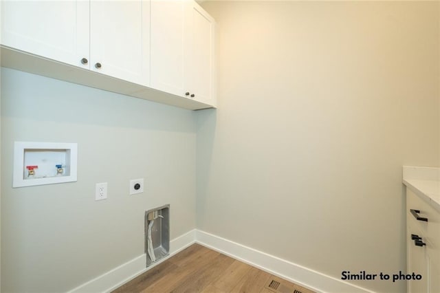 laundry room with light wood-type flooring, hookup for a washing machine, electric dryer hookup, and cabinets