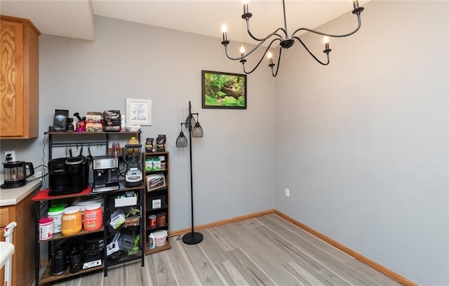 interior space with a notable chandelier and light hardwood / wood-style floors