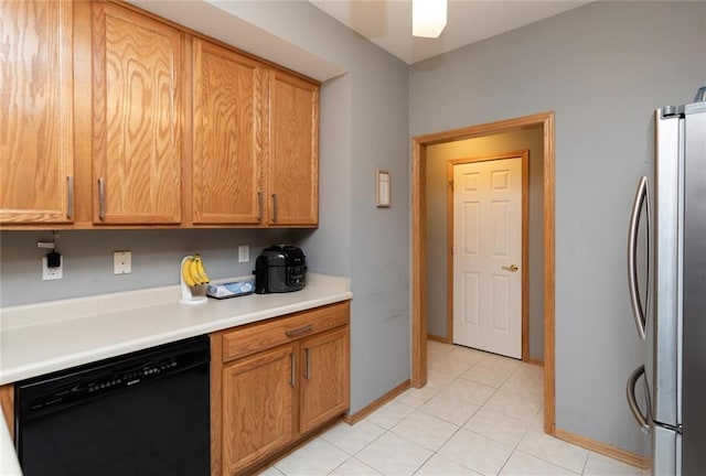 kitchen featuring light tile patterned floors, stainless steel fridge, and dishwasher