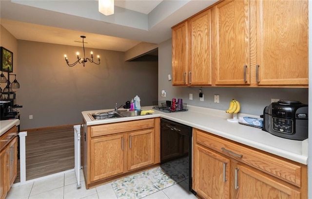 kitchen featuring dishwasher, pendant lighting, kitchen peninsula, sink, and light tile patterned floors