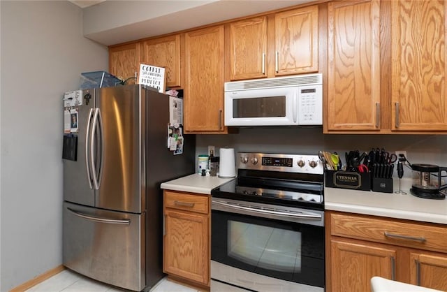 kitchen with light tile patterned floors and appliances with stainless steel finishes