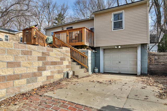 back of property with a garage and a deck