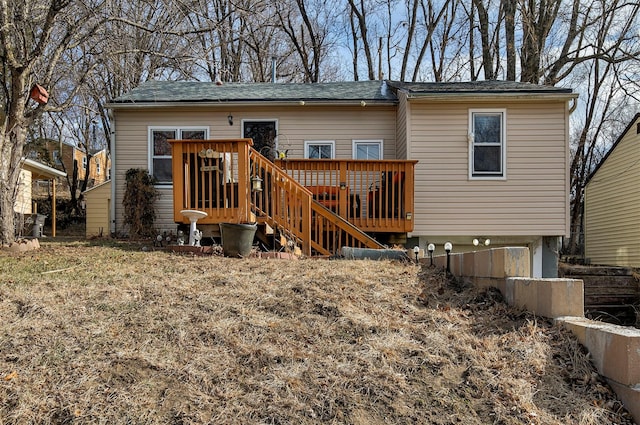 rear view of property featuring a deck