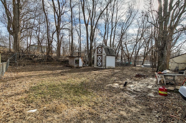 view of yard with a storage unit and an outdoor fire pit