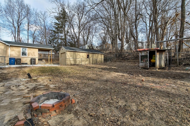 view of yard featuring a fire pit and a shed