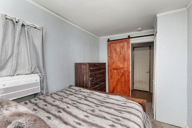 carpeted bedroom featuring ornamental molding, a barn door, and a wall mounted air conditioner