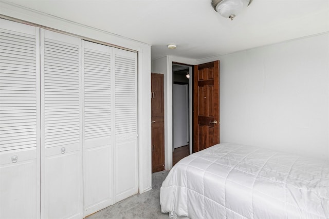 bedroom featuring light carpet and a closet