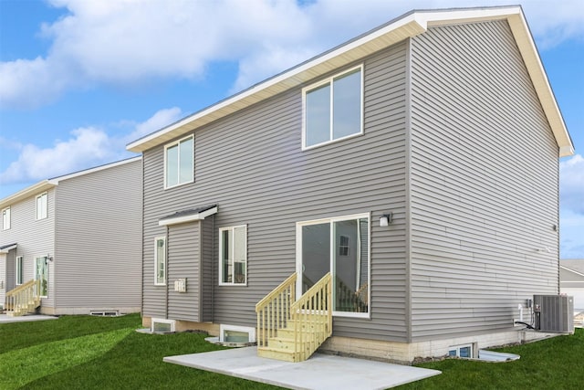 rear view of house with entry steps, a lawn, and central AC unit