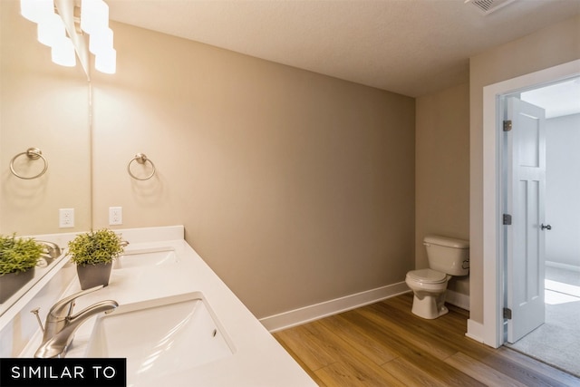 bathroom featuring hardwood / wood-style floors, toilet, and vanity