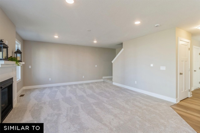 unfurnished living room with light carpet