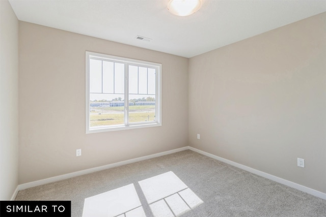 unfurnished room featuring light colored carpet