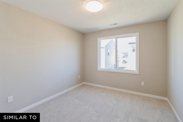 unfurnished room featuring light carpet