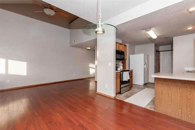 kitchen with ceiling fan, stainless steel electric stove, white fridge with ice dispenser, a textured ceiling, and light hardwood / wood-style flooring