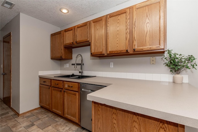 kitchen featuring sink, a textured ceiling, and dishwasher