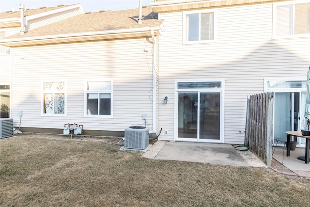 back of property featuring a lawn, central AC unit, and a patio area