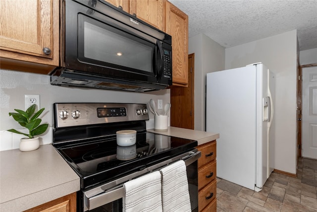 kitchen featuring white fridge with ice dispenser, a textured ceiling, and stainless steel range with electric stovetop