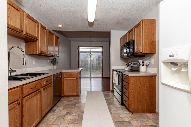 kitchen with sink, hanging light fixtures, black appliances, and a textured ceiling