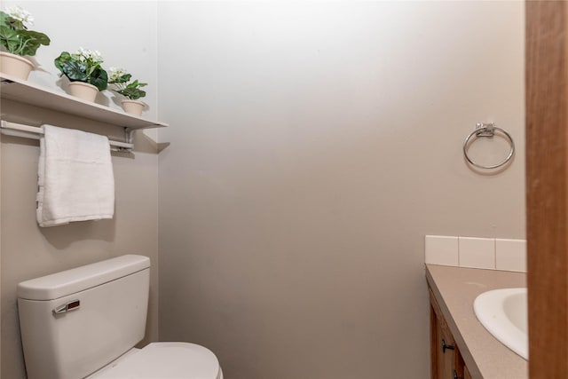 bathroom with toilet and vanity