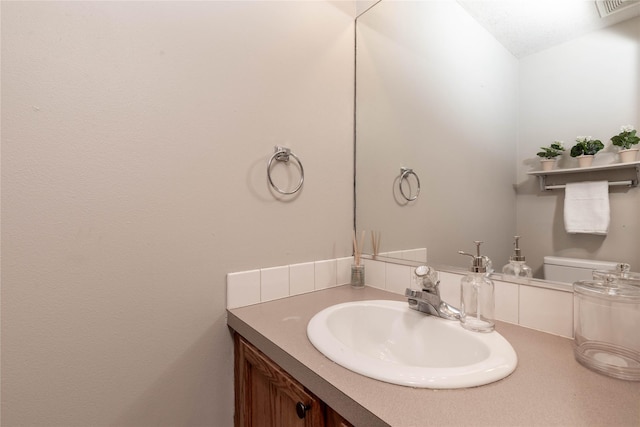 bathroom featuring toilet and vanity