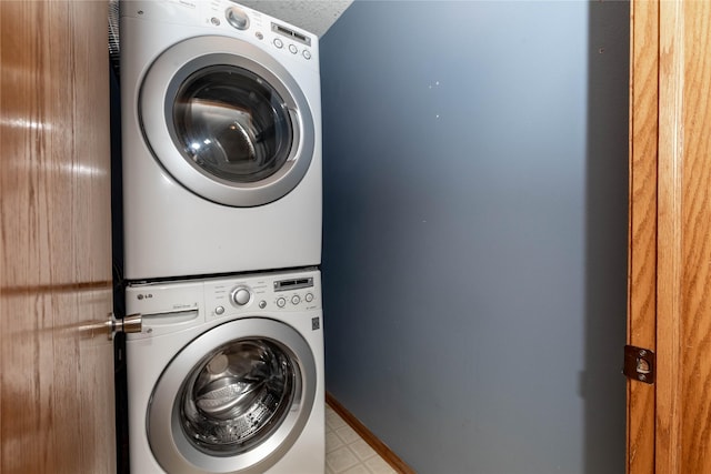 clothes washing area with stacked washer / dryer and a textured ceiling