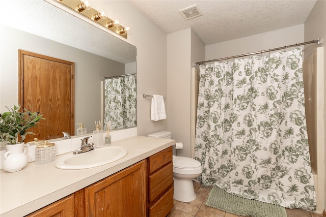 bathroom featuring a textured ceiling, toilet, and vanity