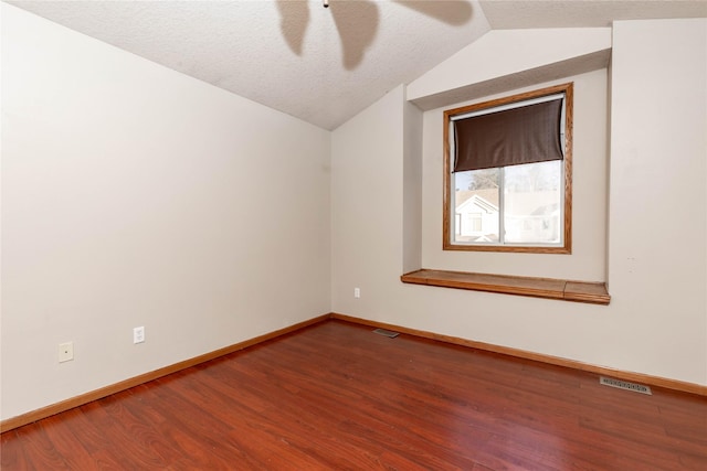 additional living space with ceiling fan, hardwood / wood-style floors, lofted ceiling, and a textured ceiling