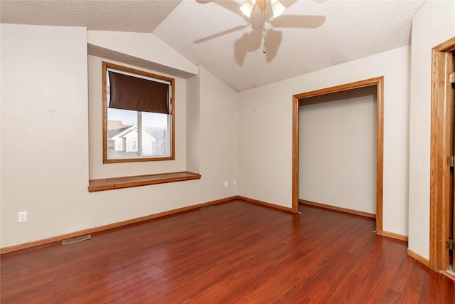 unfurnished bedroom with vaulted ceiling, ceiling fan, a textured ceiling, and hardwood / wood-style flooring