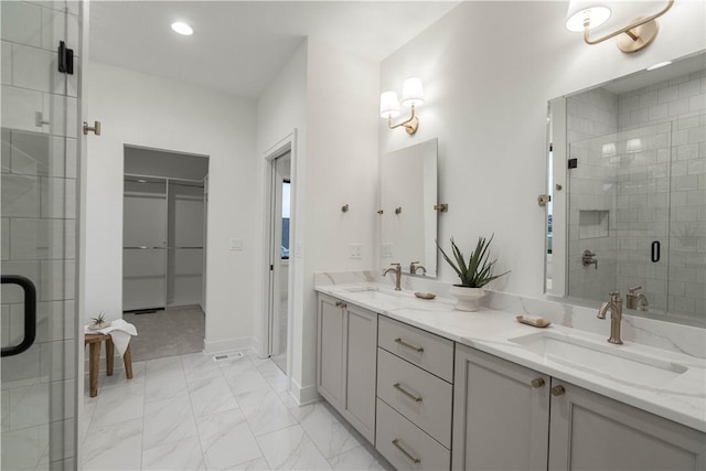 bathroom with vanity and a shower with door