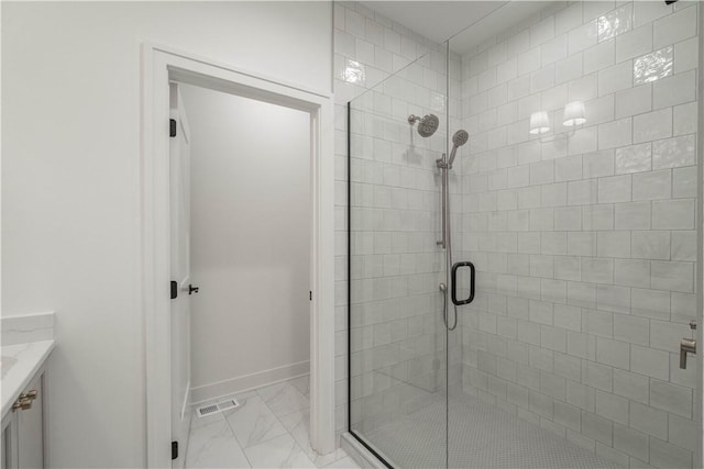 bathroom with walk in shower and vanity