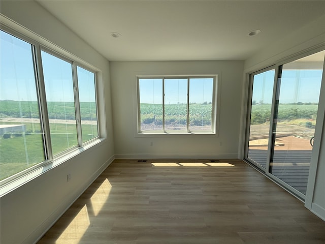 3034 NW Beechwood Dr, Grimes, IA 50111 - unfurnished sunroom with wood finished floors and recessed lighting