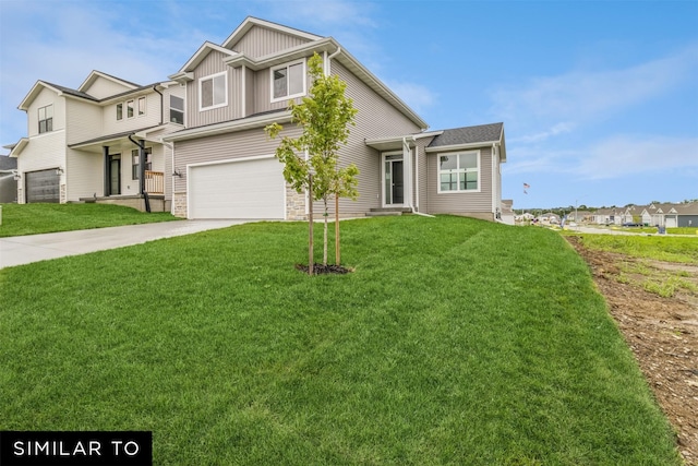 view of front of home featuring a front yard and a garage