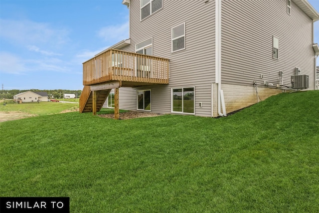 back of house with central AC, a wooden deck, and a yard