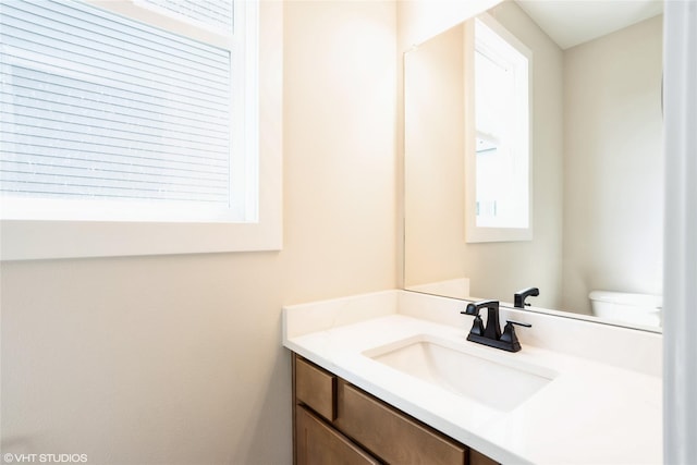 half bathroom with toilet and vanity