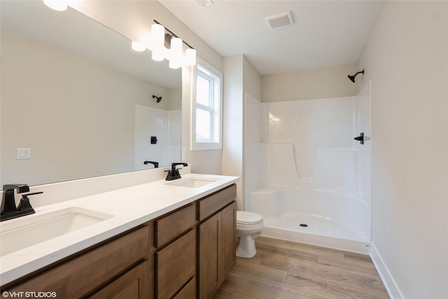 full bathroom featuring walk in shower, visible vents, a sink, and toilet
