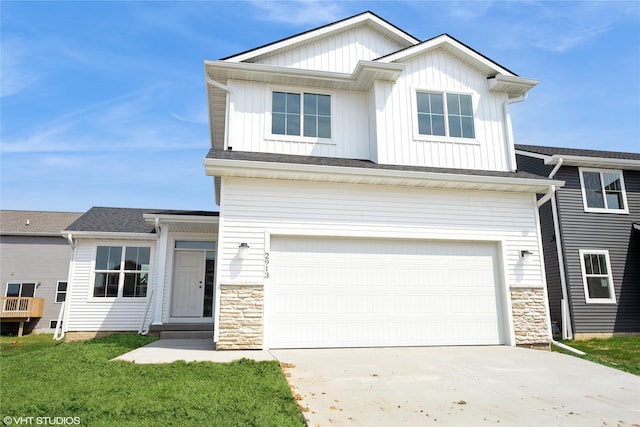 view of front of property with an attached garage, driveway, stone siding, and board and batten siding