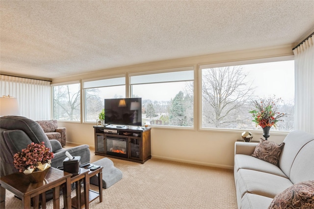 living room with plenty of natural light, a textured ceiling, and light carpet