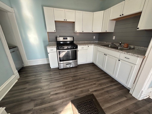 kitchen with dark hardwood / wood-style floors, sink, white cabinetry, and stainless steel stove