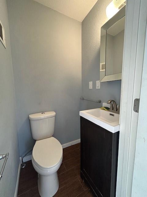 bathroom with toilet and vanity