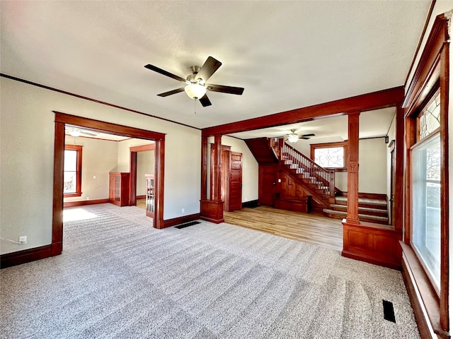 unfurnished living room with ceiling fan and light colored carpet