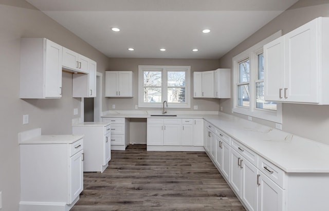 kitchen featuring sink, white cabinetry, and dark hardwood / wood-style flooring