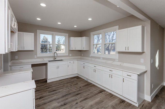 kitchen with sink, white cabinets, and dark hardwood / wood-style flooring