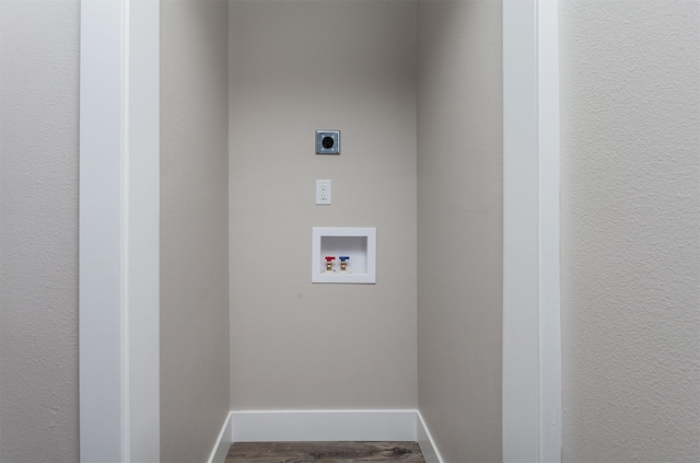 washroom with hookup for an electric dryer, hardwood / wood-style flooring, and washer hookup