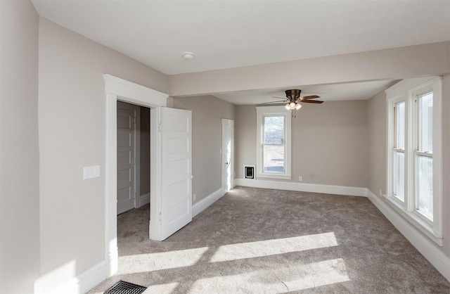 spare room featuring plenty of natural light and light colored carpet