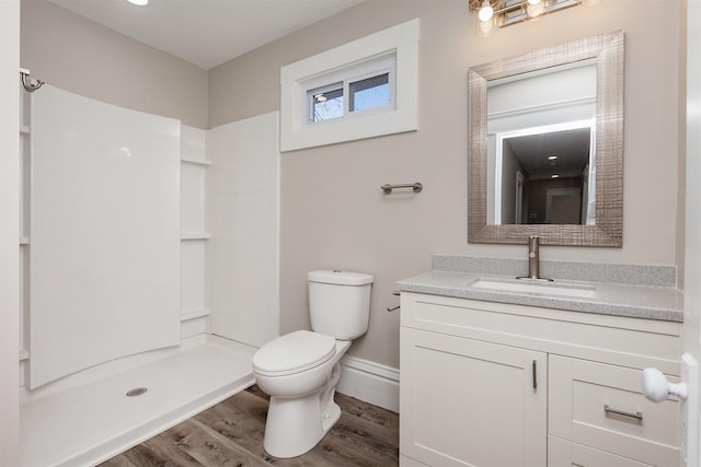 bathroom with vanity, toilet, walk in shower, and hardwood / wood-style floors