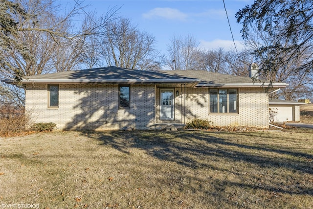 view of front of home with a garage and a front lawn