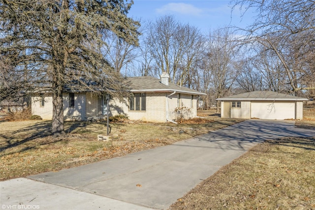 view of front of home with a garage, an outdoor structure, and a front lawn