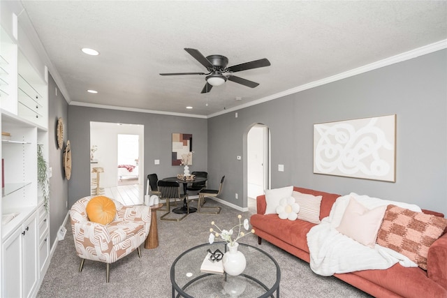 living room with ceiling fan, carpet flooring, crown molding, and a textured ceiling