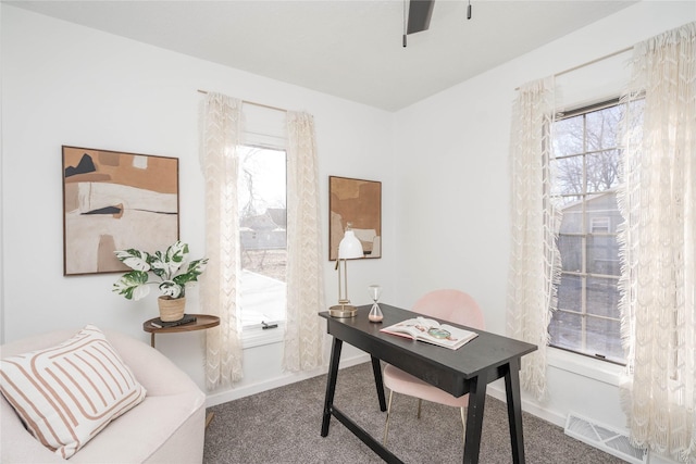 office area with ceiling fan, carpet flooring, and plenty of natural light