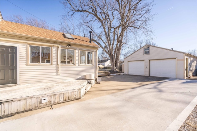 view of side of property with an outdoor structure and a garage